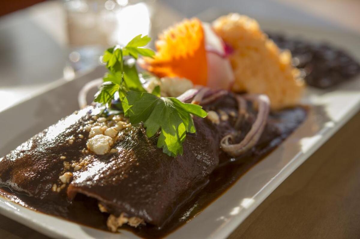 Enmoladas have shredded chicken and red mole at Mezcalito Oaxacan Cuisine.