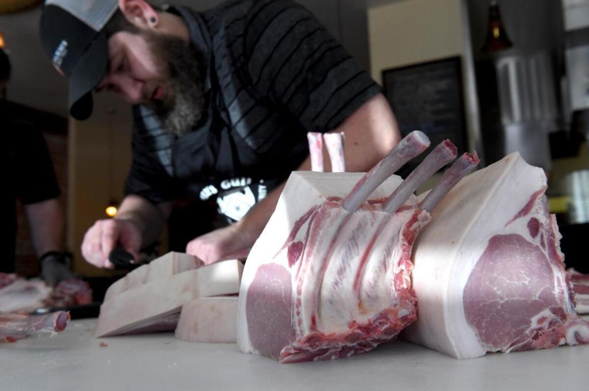 Bryan Butler, winner of the best butcher in Austin, Texas, cuts pork chops as he and members of Team USA for the World Butchers’ Challenge 2018 do a practice run at Taylor’s Meat Market on Aug. 7, 2017.