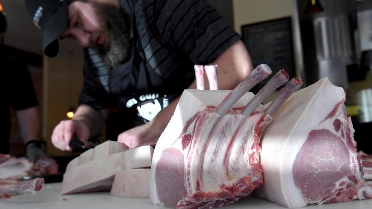 Bryan Butler, winner of the best butcher in Austin, Texas, cuts pork chops as he and members of Team USA for the World Butchers’ Challenge 2018 do a practice run at Taylor’s Meat Market on Aug. 7, 2017.