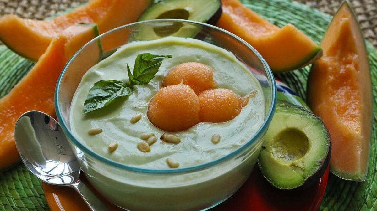 Chilled avocado and yogurt soup with melons (see recipe on Page 3D), from sheknow.com, is garnished with basil leaves and pine nuts.