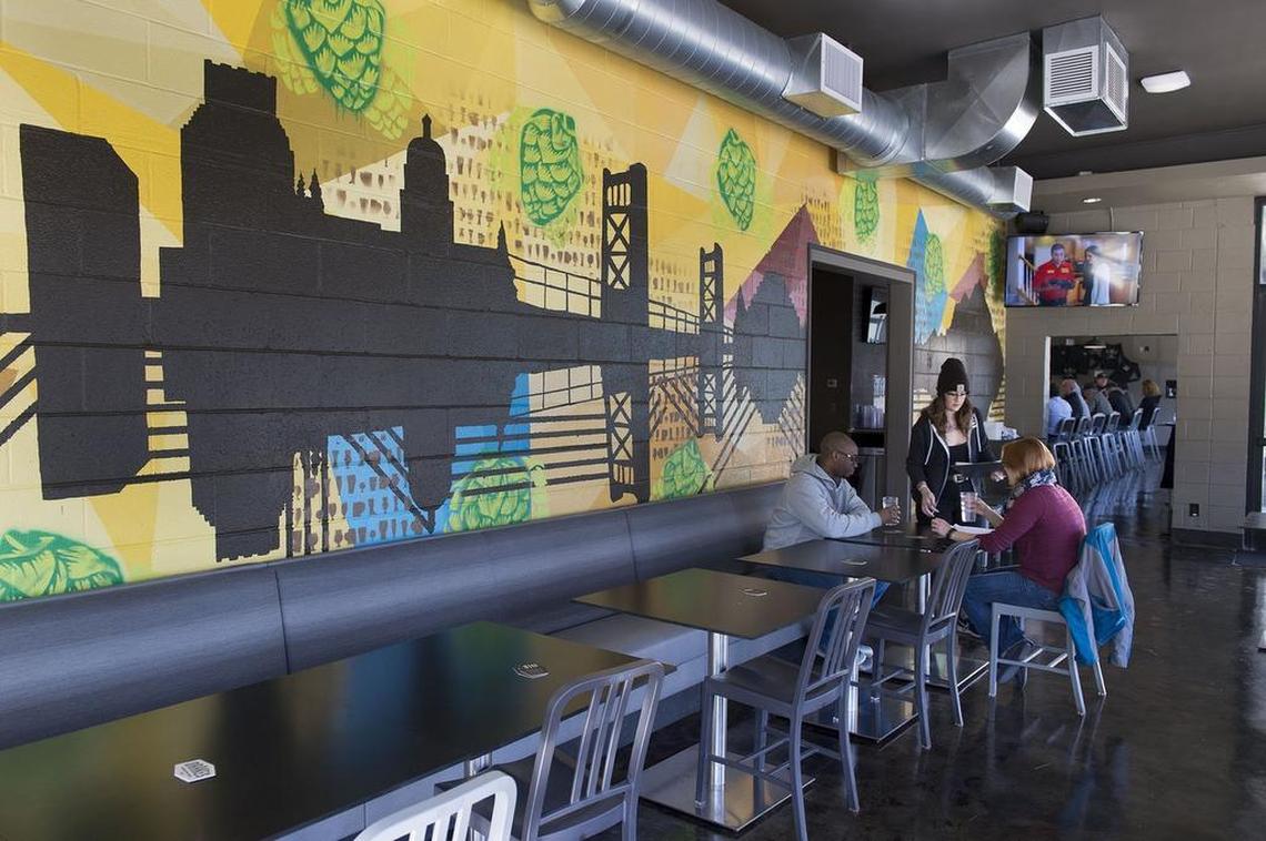 A mural of the Sacramento skyline stands out on a wall inside Capital Hop Shop.