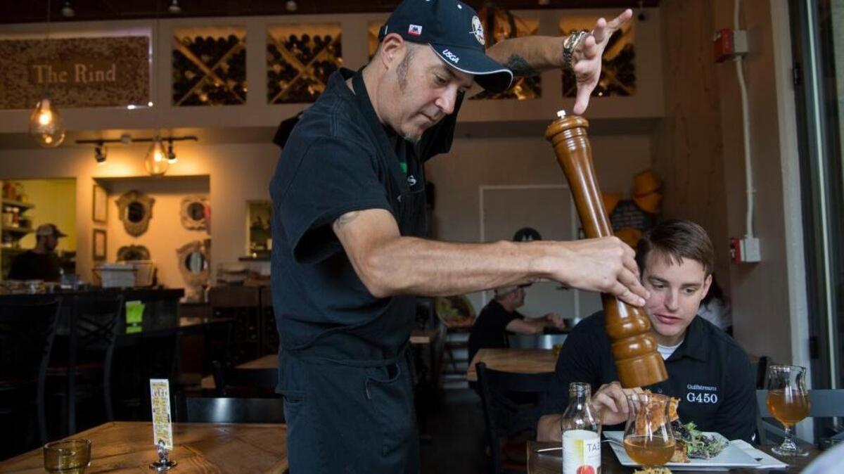 
Tony Lovato, a server at The Rind, grinds pepper for a lunch customer on Tuesday, Oct. 13, 2015. Lovato has been a waiter for 25 years in Sacramento. Sacramento City Council prepares to vote Oct. 27 on a gradual minimum wage increase to $12.50 an hour over the next five years, well above the state-mandated $9 hourly wage. That worries many restaurant owners, and they’re supporting a “carve-out” clause that excludes people from the wage hike if their total compensation exceeds $15 an hour.
