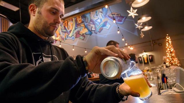 Head brewer Zack Frasher pours a glass of Yojo IPA at the Moonraker Brewing Company in Auburn.