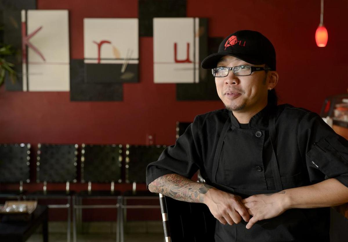Bill Ngo sits at sushi bar at his restaurant Kru on July 11, 2013.
