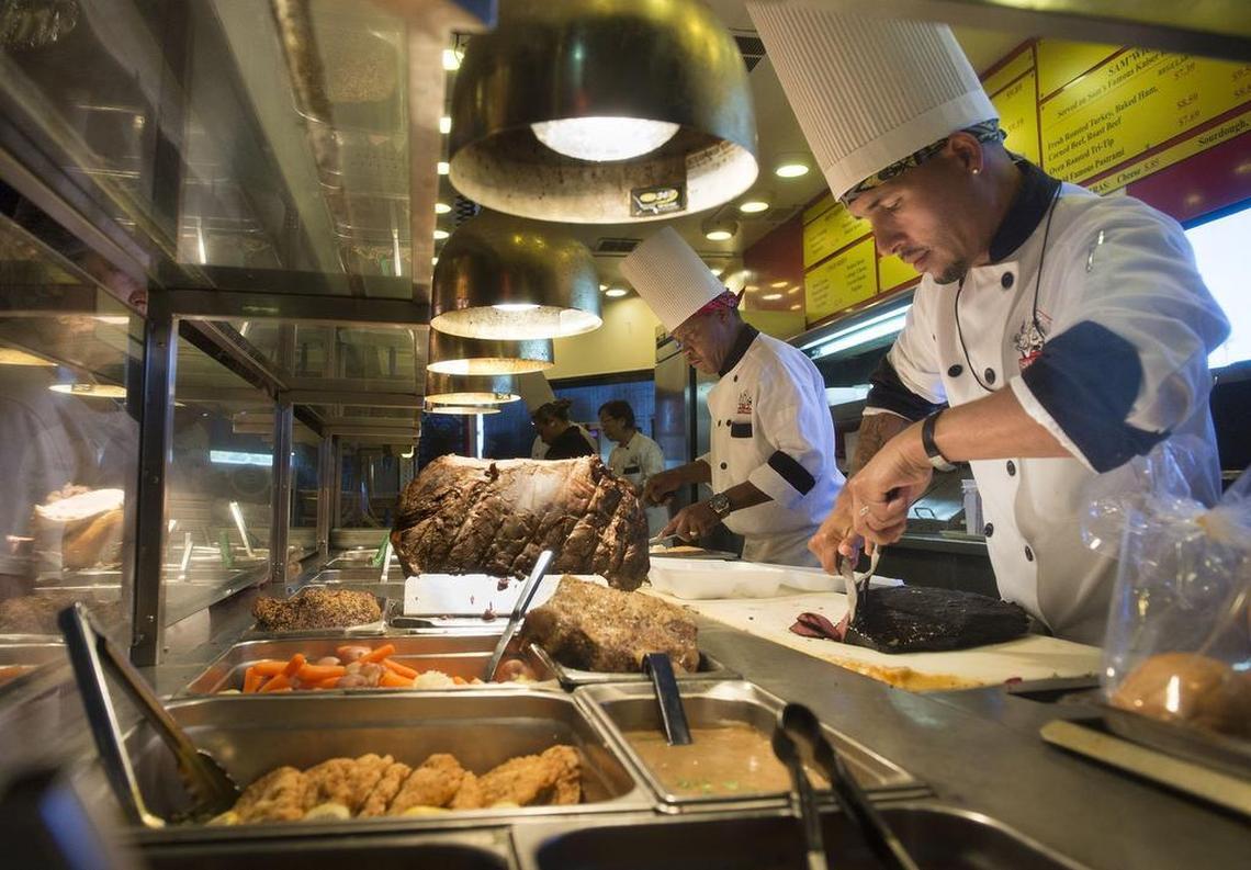 General manager Pedro Tirado, a 26-year employee, slices pastrami during lunch at Sam’s Hof Brau in Arden Arcade in 2017.