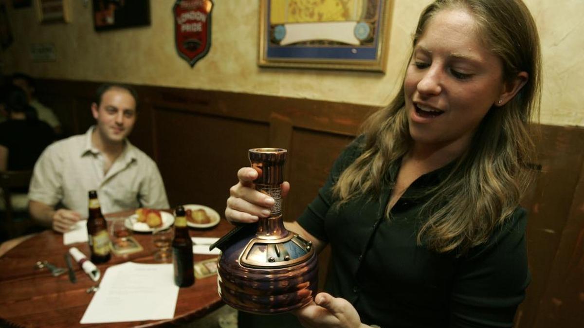 Jay Edelstein, left, watches as Shari Doulman checks out a copper kettle-styled bottle of Samuel Adams Utopias beer in 2005. The beer has a 28 percent alcohol content by volume, a level illegal in 12 states.