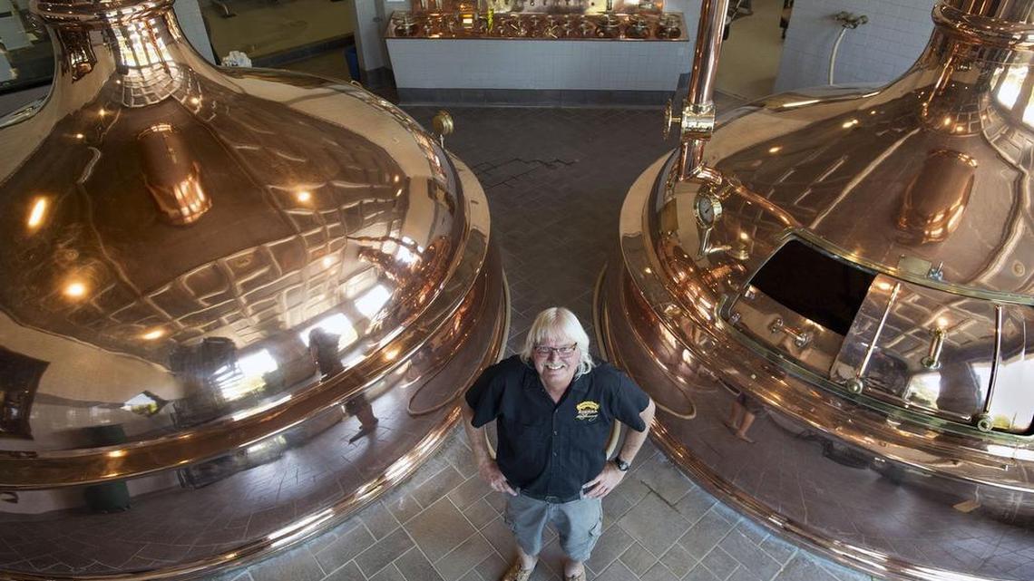 Steve Dresler, the longtime brewmaster at Sierra Nevada Brewing Co. stands between the lauter tun, left, and kettle where he brewed after the first expansion in 1989, on Tuesday in Chico. Dresler is retiring next month after 34 years with the popular brewing company.