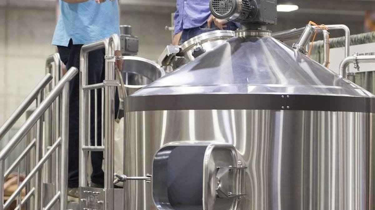 Alan Bosch, left, and his son, Justin Bosch of Santa Rosa, who are in the beginning stages of opening a brewery, check out a stainless steel brewhouse at the 2016 California Craft Beer Summit at the Sacramento Convention Center on Friday, September 9, 2016 in Sacramento.