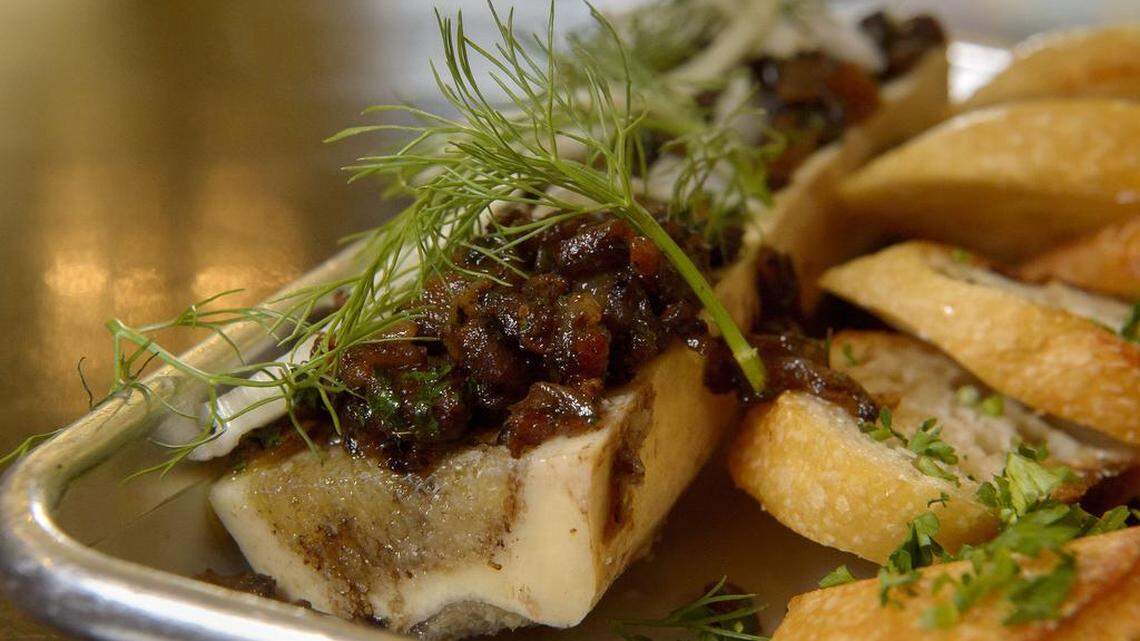 The bone marrow topped with bacon jam and organic citrus fennel served with grilled sourdough baguette at Backbone Café.
