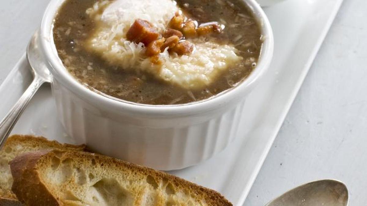 Italian-style onion soup is topped with a poached egg.