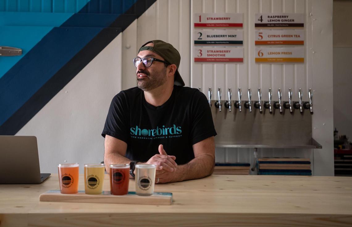 Owner Randall Echeverria stands behind the bar at Shorebirds Brewing Company, the Sacramento region’s first hard kombucha brewery and taproom, on Thursday in Rancho Cordova.