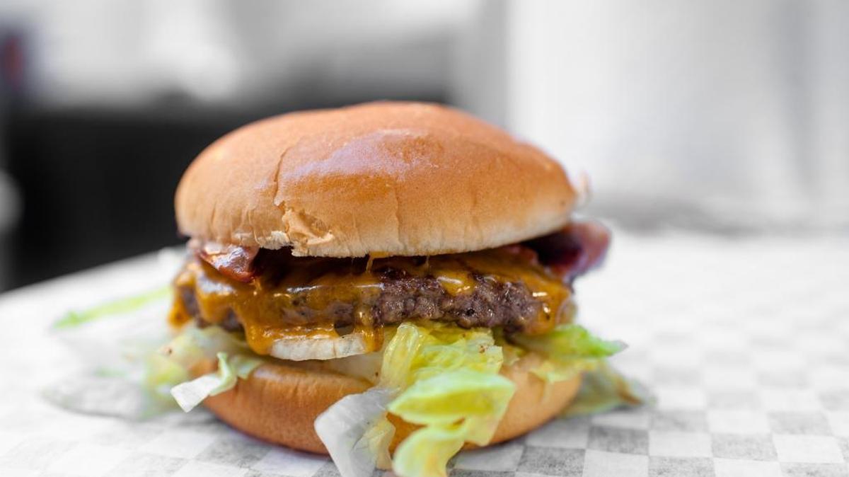 Empress Tavern’s winning burger, featuring two three-ounce patties, a slice of sharp American cheese, onion relish, iceberg lettuce and, for a pork element on top, mortadella that’s been crisped up like fried baloney. A remoulade sauce topps the creation.