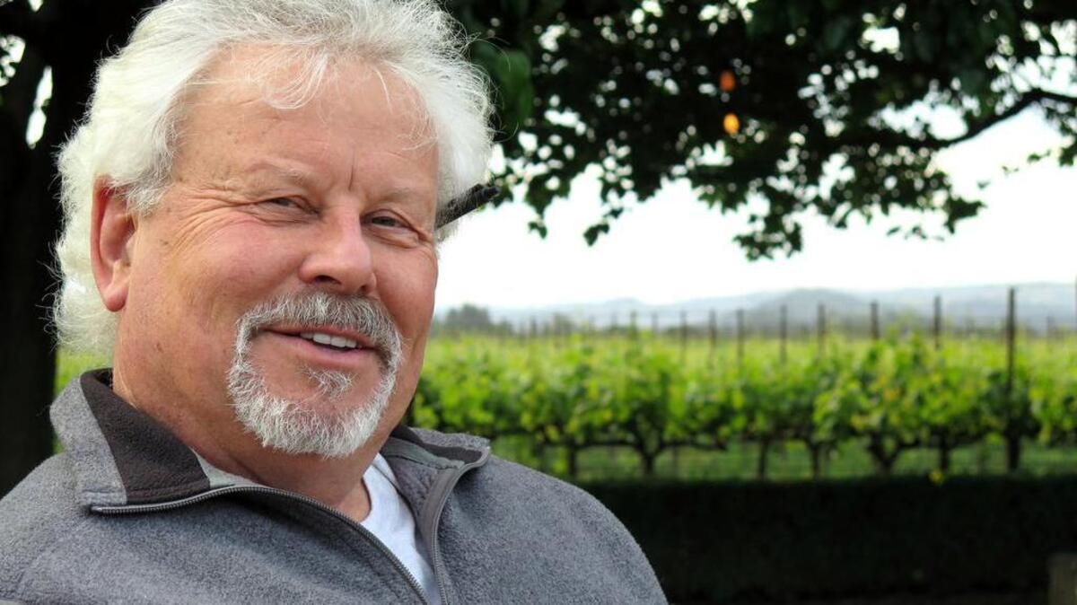 Winemaker Jim Moore of the brands Uvaggio and a’Campo stands in a vineyard – not his – in Napa Valley.