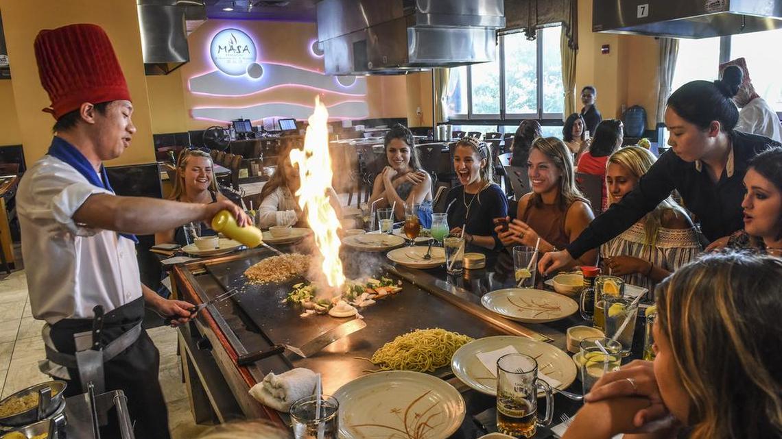 A chef cooks for a group celebrating a birthday at Masa Hibachi Steakhouse & Sushi in Silver Spring, Md. Some Chinese chefs are switching to Japanese food to boost profits.
