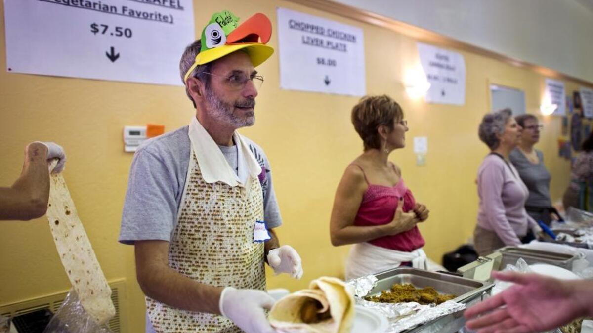 
At Congregation Beth Shalom’s Jewish Food Faire, foods including vegetarian falafel, which Howard Spivak served at the 2013 event, are the star attraction. 
