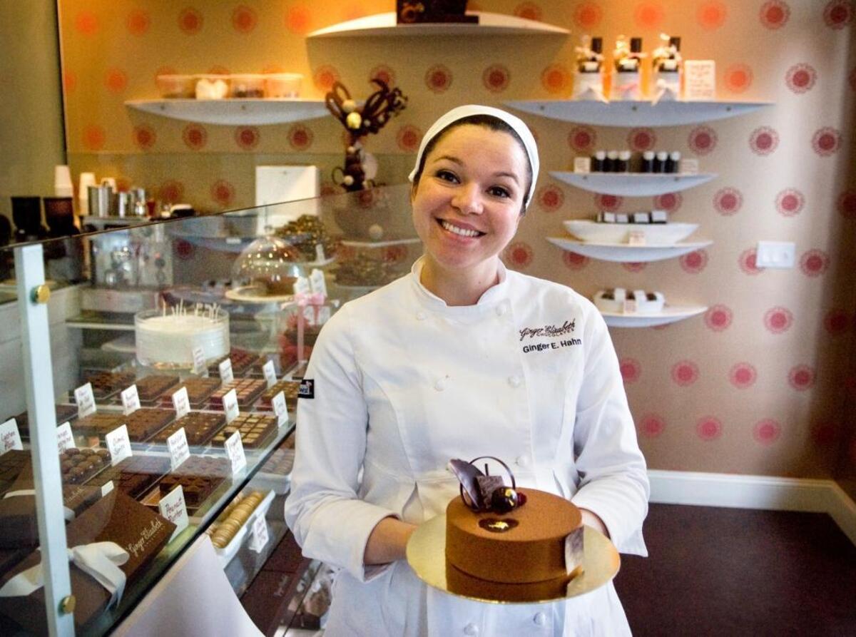 Ginger Elizabeth Hahn shows off a treat from her store, Ginger Elizabeth Chocolates, in 2009.