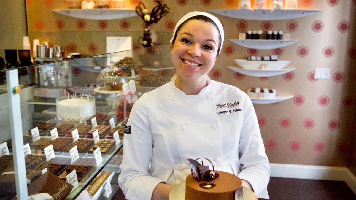Ginger Elizabeth Hahn shows off a treat from her store, Ginger Elizabeth Chocolates, in 2009.