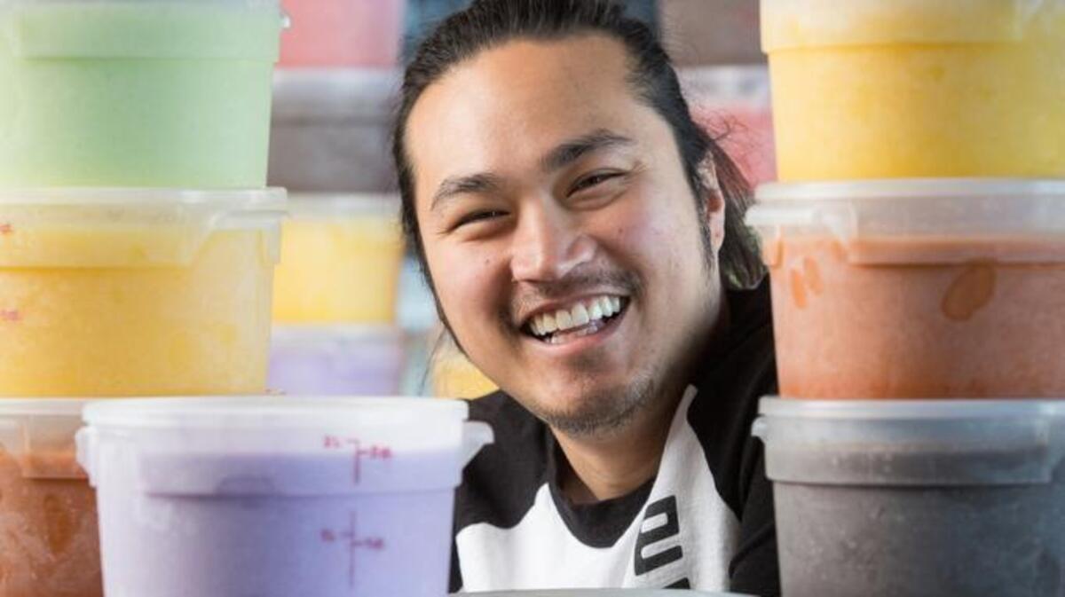 Paolo San Luis of Vampire Penguin, above, is surrounded by some of the restaurant’s eclectic flavors of “shaved snow.” At left, the strawberry cheesecake shaved snow is made from a base of strawberry and vanilla shaved ice, then sprinkled with graham cracker crumbs, strawberries and raspberries. Finally, it’s drizzled with white chocolate, condensed milk and strawberry sauce.