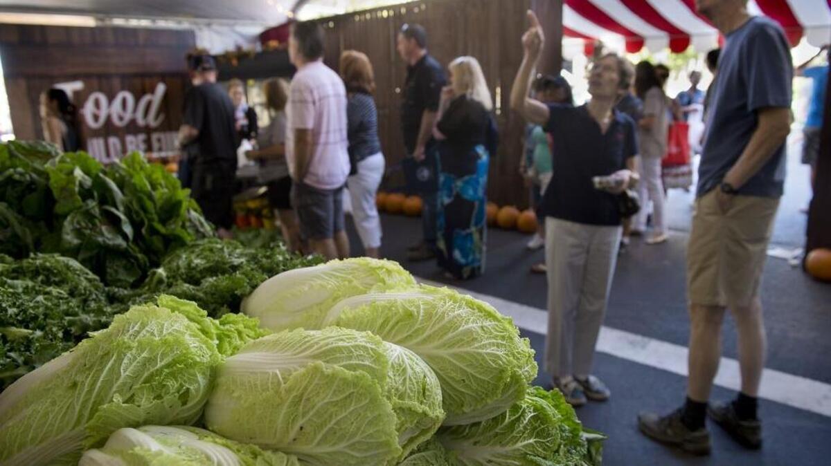 
People mingle amid at the produce at the inaugural Farm-to-Fork Festival two years ago on the Capitol Mall.
