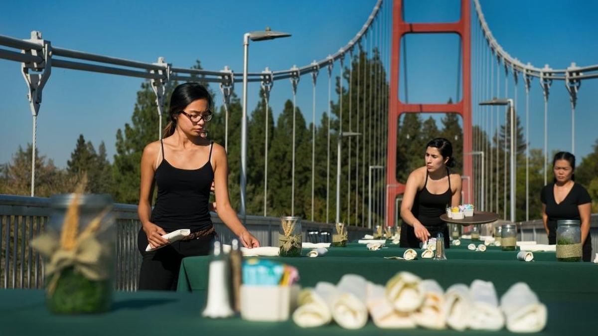 Sacramento State University Family and Consumer Science Majors set up tables on Guy West Bridge before their upcoming Farm-to Fork at Sac State dinner on Wednesday Sept. 13, 2016. On the left its Hanna Romanos of Sacramento. The proceeds of the $50 per person dinner benefit the Associated Students Inc. Food Pantry on campus. Besides the view, the dinner features sustainable, locally sourced ingredients and are prepared by Sacramento State Students.