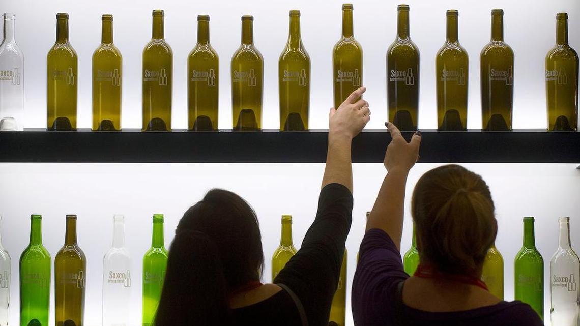 Liz Avalos, left, and Lisa Brand of Lodi examine wine bottles displayed during the Unified Wine & Grape Symposium in Sacramento on Wednesday, Jan. 27, 2016.