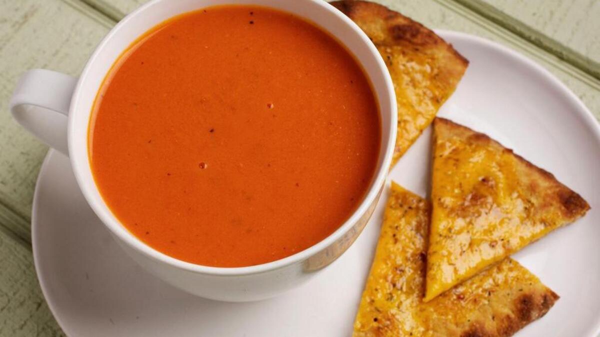 No cream is used in this tomato soup. Instead, bread and olive oil emulsify in the blender with the other ingredients to create the rich texture.