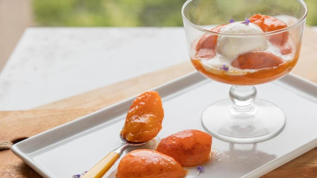 Pan-grilled apricots are served with honey-orange lavender syrup.