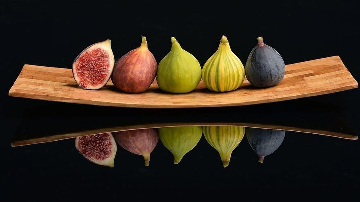 The availability of fresh figs, as opposed to dried ones, has increased lately. From left are a sliced Brown Turkey fig, Brown Turkey fig, Sierra fig, Tiger fig and Black Mission fig.