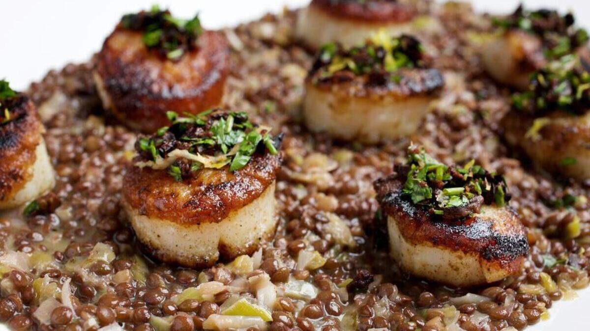 The spiciness of the gremolata sauce is a perfect counter to the sweet scallops in this dish. The bed of lentils with leeks is one option for serving.