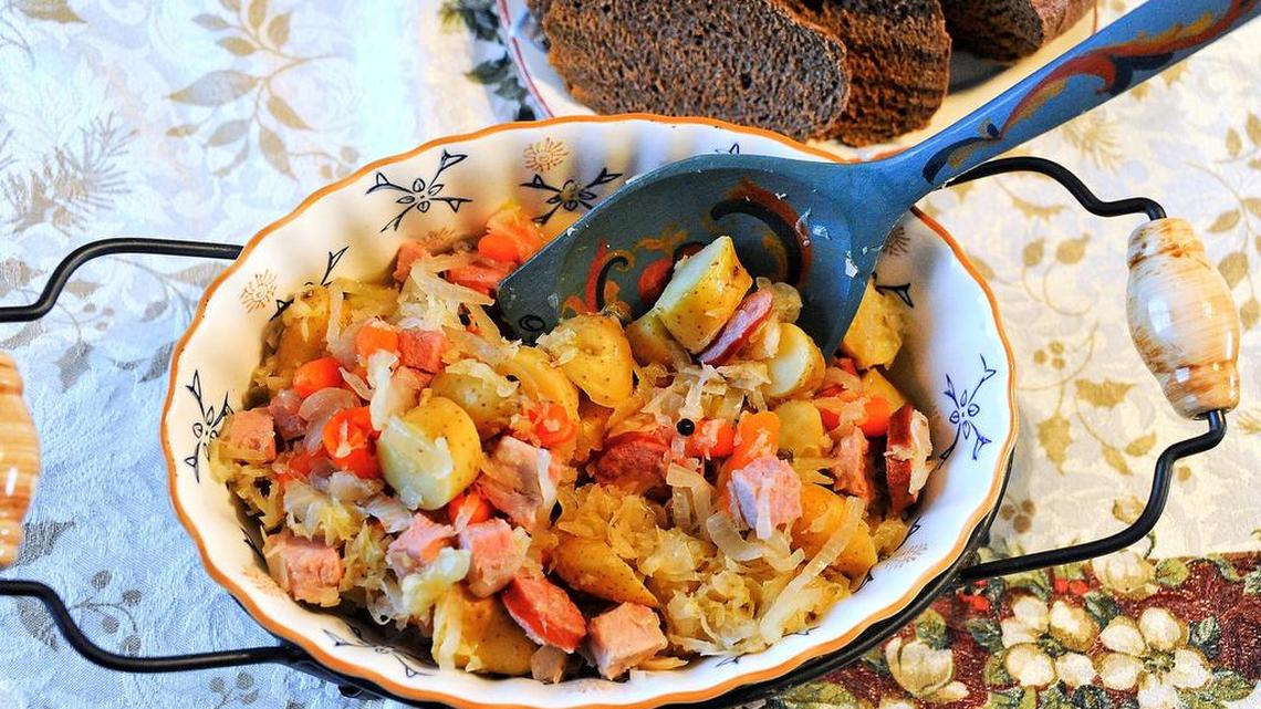 Skillet choucroute garni (sauerkraut with kielbasa and cubed ham, potatoes and carrots) goes well with pumpernickel bread.