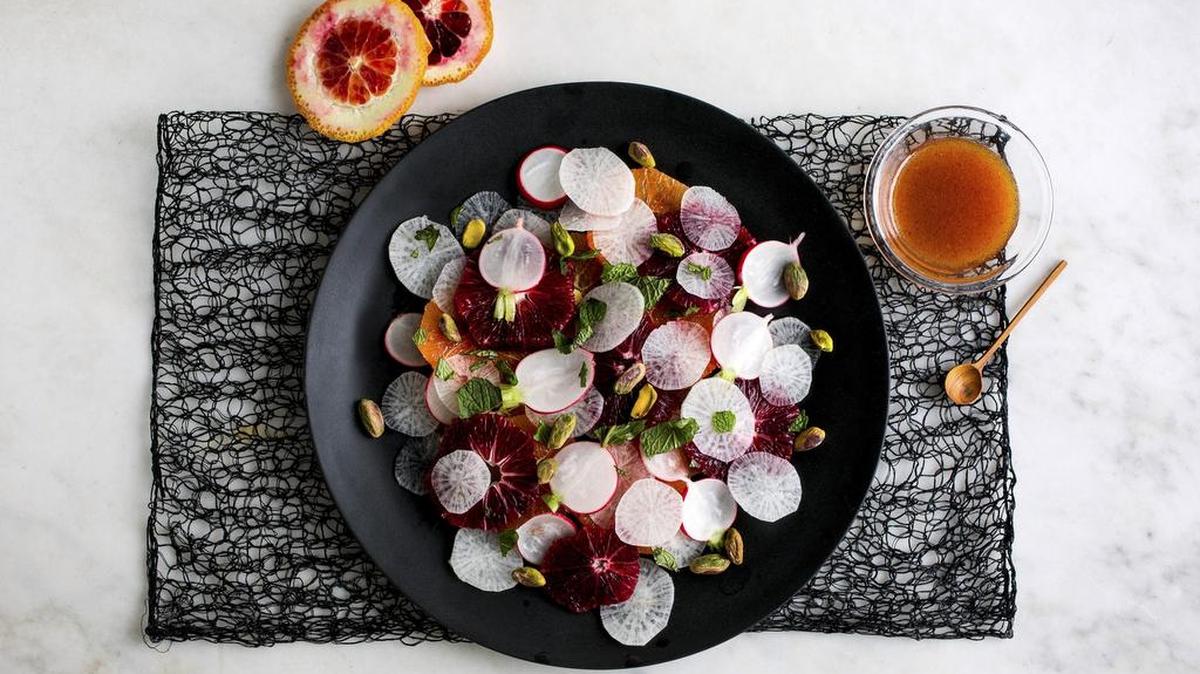 A citrus and radish salad with both blood and navel oranges, a beautiful mix of red and purple radishes and daikon, all dressed with roasted pistachio oil