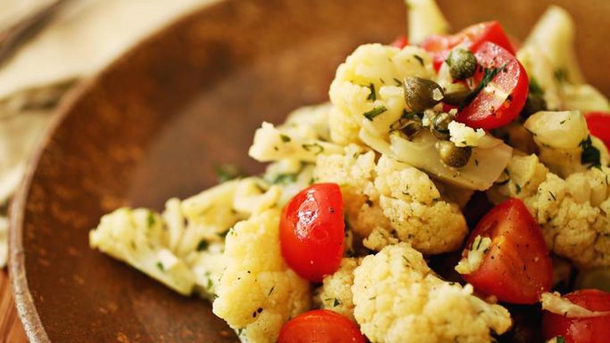 Pan-seared cauliflower with capers is steamed first in a skillet and then pan-seared for flavor. You can also roast the cauliflower instead and include olives or feta for variation.