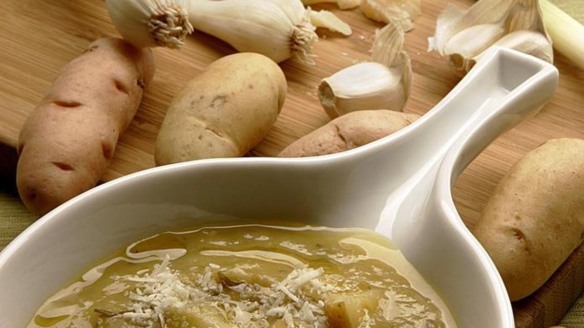 Green garlic, in background, resembles leeks or young onions. The spring veggie enhances the flavors of this potato chowder.