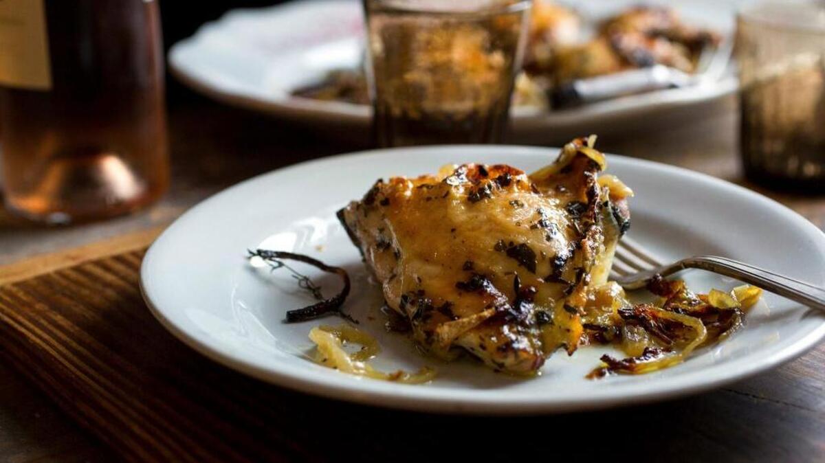 Tarragon chicken with sherry vinegar onions is served after roasting in a sheet pan.