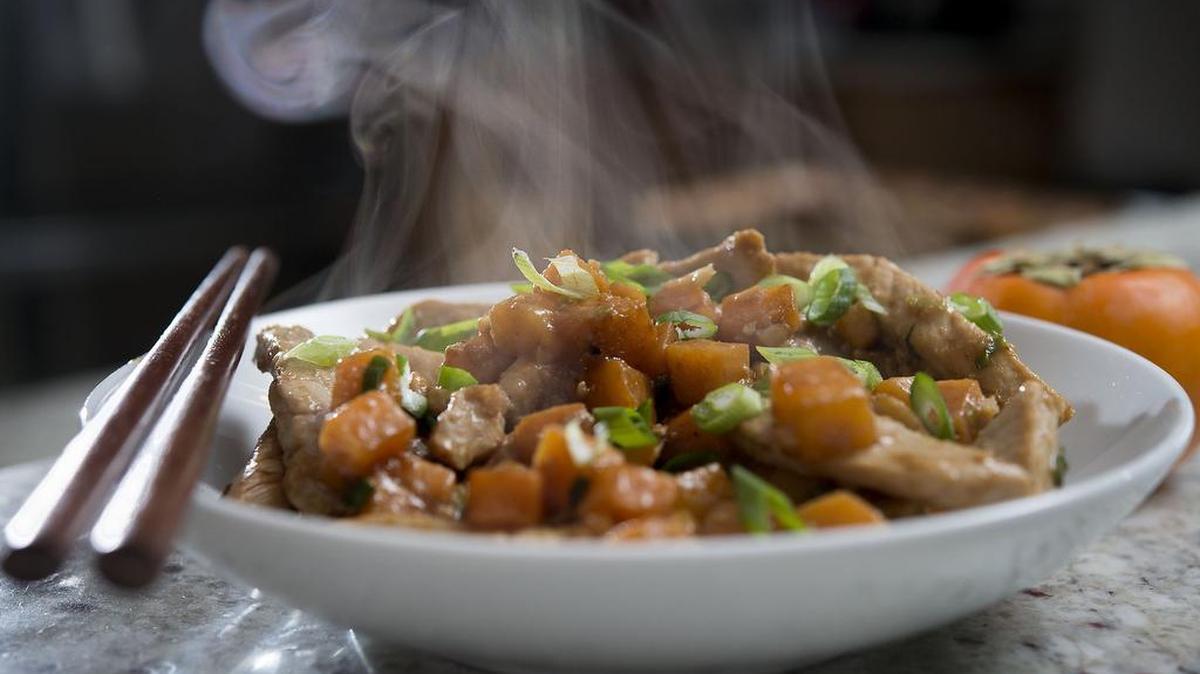 Persimmons add color and flavor to a pork stir-fry with walnuts. Cooking Fuyus (the flatter persimmons) mellows their sweetness.
