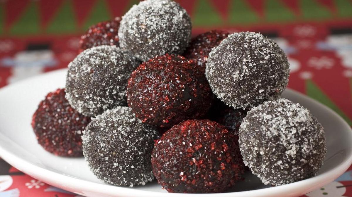 Roll rum balls in sugar to finish. Colored sugar makes a nice holiday touch.