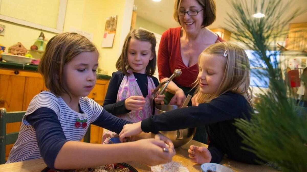 Ann Martin Rolke oversees the preparation of holiday snacks recently with, from right, Molly Louney, 6, Stella Louney, 8, and Eva Rolke, 8.