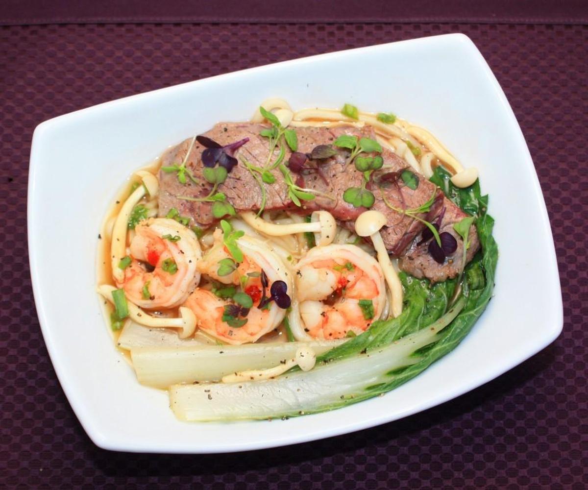 Micro Asian Mix, a specialty microgreen from Fresh Origins, both garnishes and flavors this beef and prawn udon soup.