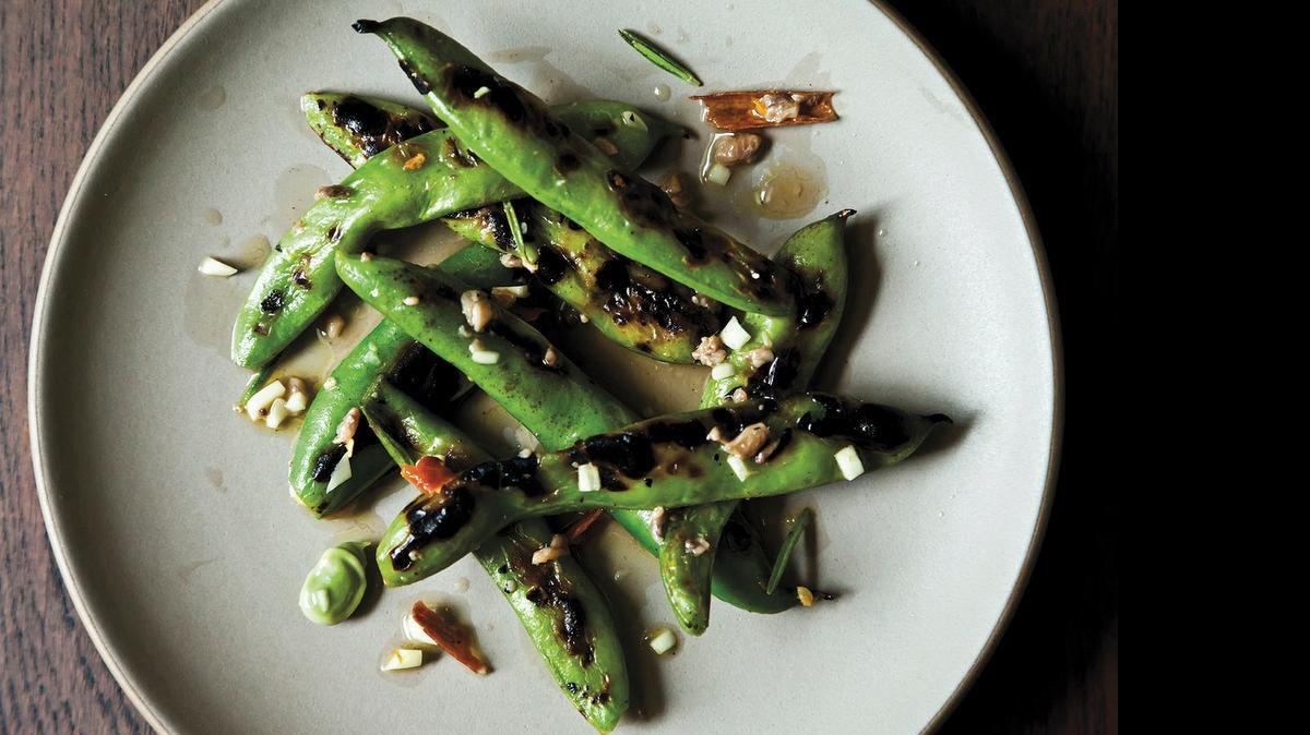 
Grilled fava beans (see recipe, Page 2D) initially are dunked in a spicy marinade, charred and redunked. Preferably, they are eaten with the hands.
