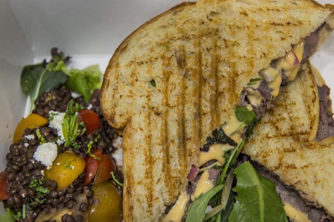 Time Out Panini consists of roast beef, mixed greens with red pepper aioli at Recess Cafe on Tuesday July 3, 2018 in Sacramento. It's served with a Hearty Lentil Salad that includes black lentils, cherry tomatoes, basil, garlic, feta with a balsamic vinaigrette. 