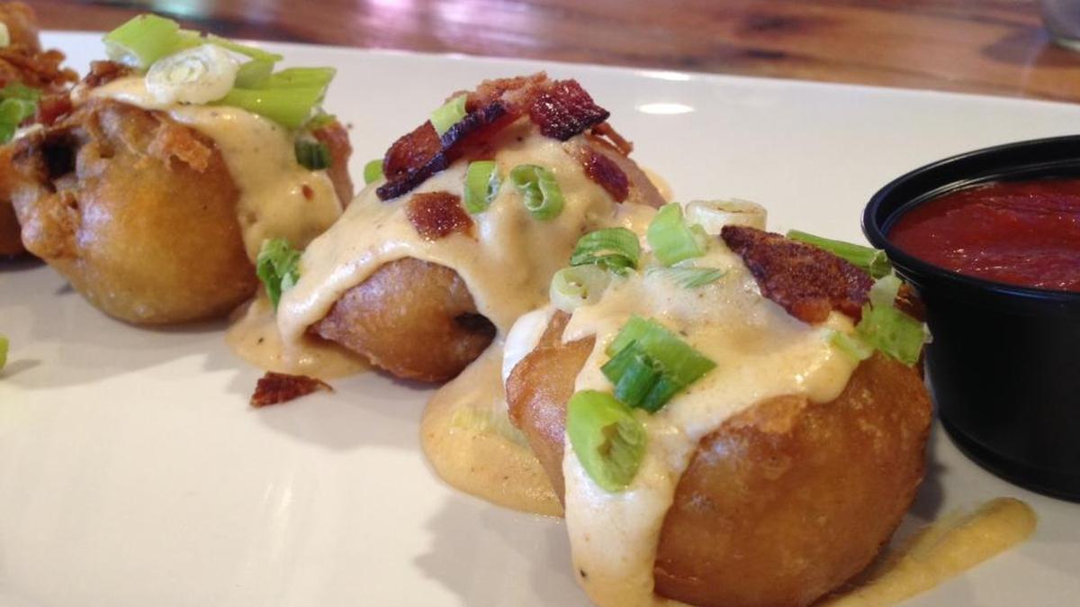 Beer-battered deep-fried mushrooms are dipped in the same house-made beer batter as coats the cod, deep-fried, then splashed with jalapeño-infused cheese sauce and sprinkled with crisp bacon bits and green onion, partnered with a side of eye-opening dipping sauce spiked with Fireball Cinnamon Whiskey at Jack Russell Brewery Downtown in Placerville.