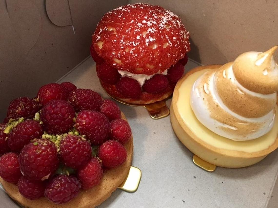 Pastries in a to-go box from Julian’s Patisserie and Cafe in Folsom are, clockwise from left, raspberry-pistachio Breton, raspberry-vanilla cream puff and lemon tart.