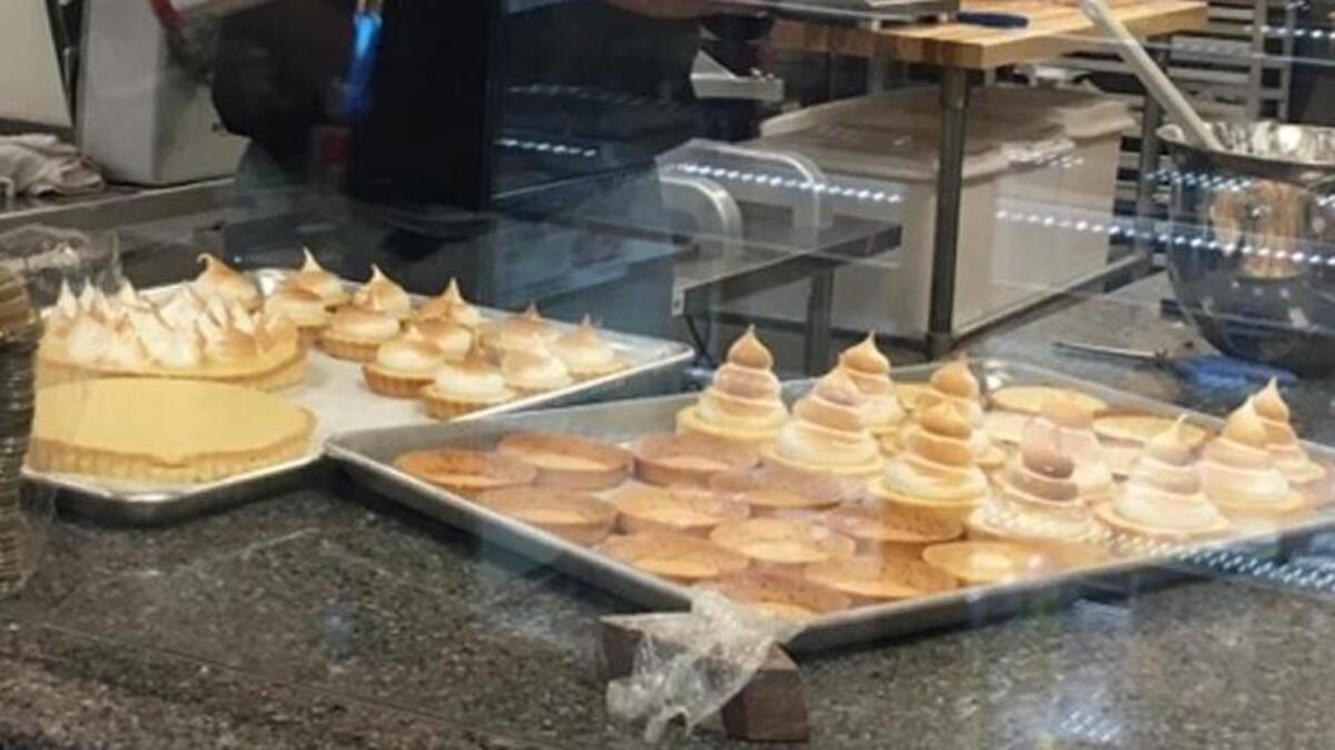 Julian Perrigo-Jimenez torches meringue topping in the open kitchen of Julian’s Patisserie & Cafe, which he co-owns with wife Ashley Perrigo-Jimenez.