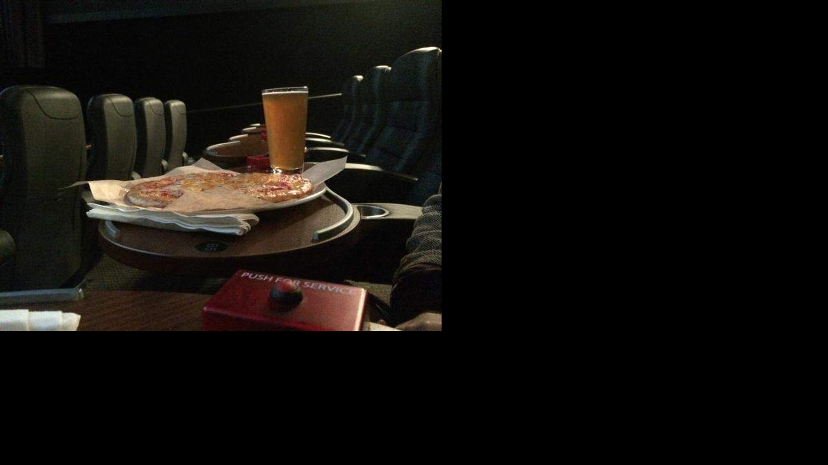 
Pizza and beer at the movie theater? Yup. At Studio Movie Grill, you press the button at the small table attached to your seat. A server responds and you place your order.
