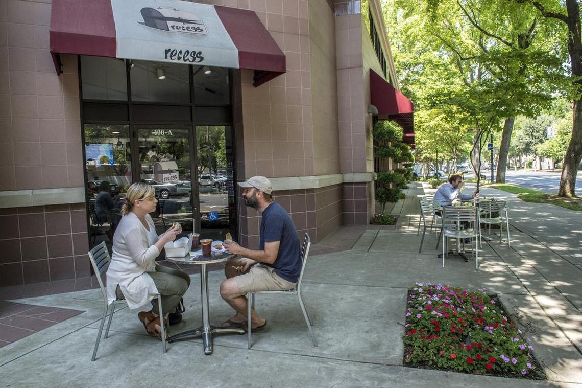 Customers enjoy their lunch at Recess Cafe on Tuesday July 3, 2018 in Sacramento. The cafe is mostly take out but does have some seating inside and out. 