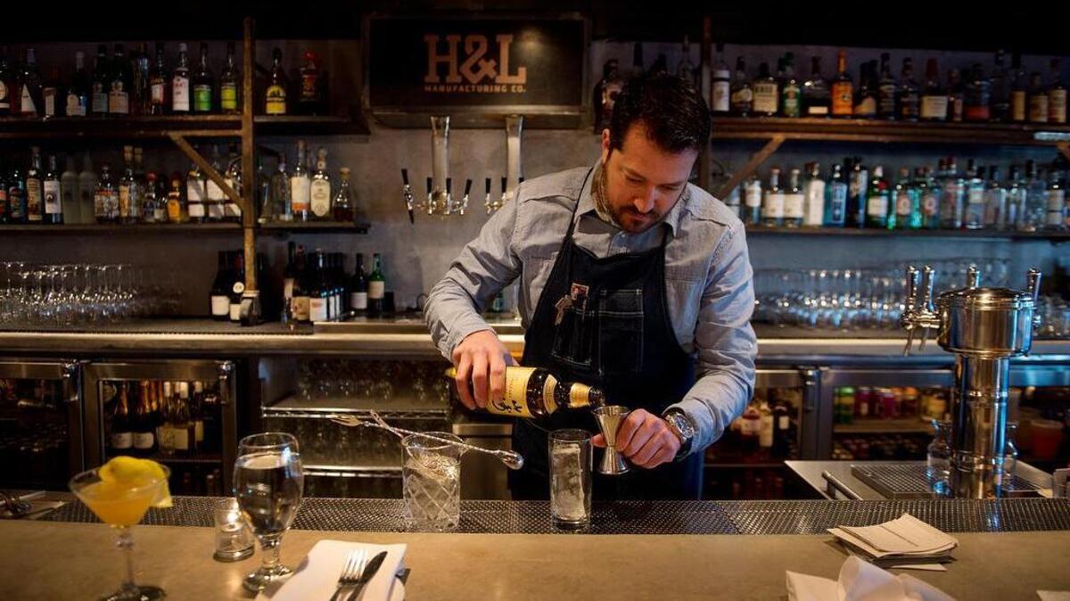 Beverage Director Chris Tucker mixes a Yamazaki Mizuwari with a hand-carved ice cube at the Hook & Ladder on S Street in Sacramento.