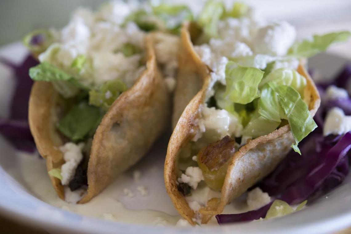  Deep-fried tacos with potatoes (cooked separately) and fire-roasted poblano peppers, topped with lettuce, cheese and crema at Cafe Capricho in East Sacramento. The cafe will close after nearly 16 years in business on Jan. 16, 2026, the restaurant announced on Facebook.