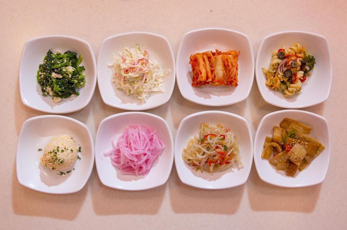 Banchan at Blue House: spinach and tofu, seaweed jelly noodles, kimchi, pasta salad, potato salad, daikon radish, bean sprouts, fish cake.