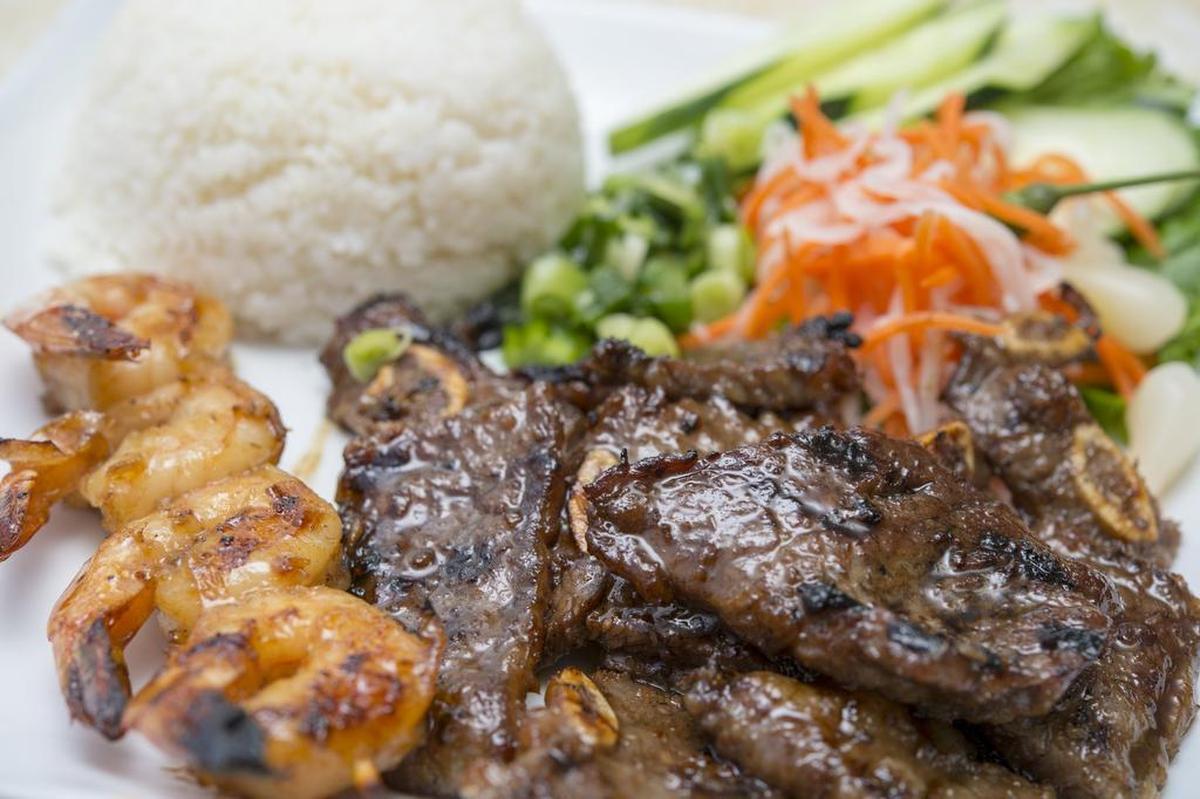 Broken rice plate with beef ribs and grilled skewered shrimp.