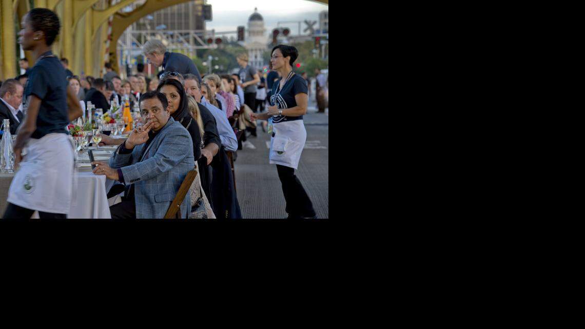 
Sami Qureshi, center, of Sacramento listens as local politicians address diners at the second Farm-to-Fork Tower Bridge Dinner on Sept. 28.
